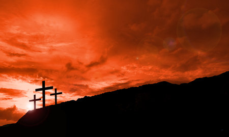 Silhouette of christian cross on the sunset sky background.の写真素材