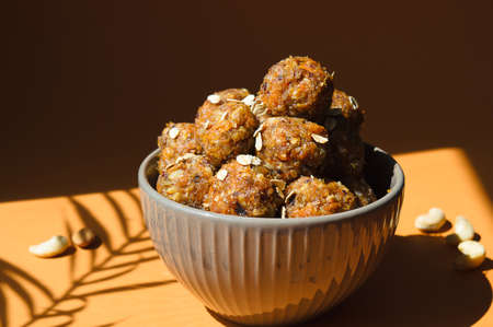 Raw energy balls. Candy vegan balls of dates, raisins, almonds, cashews, dried apricots, oatmeal.の写真素材