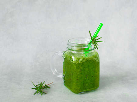 Green smoothie in glass jar made from spinach, celery, orange, apples. Detox concept, healthy food, diet, vegetarian Copy space. Healthy breakfast. Weight loss.の写真素材