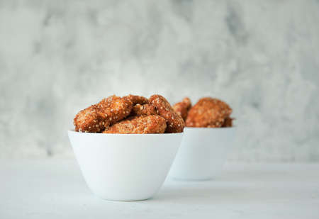 Homemade chicken nuggets with ketchup on a white table, top view, copy space. Fast food concept. Chicken chops.の写真素材