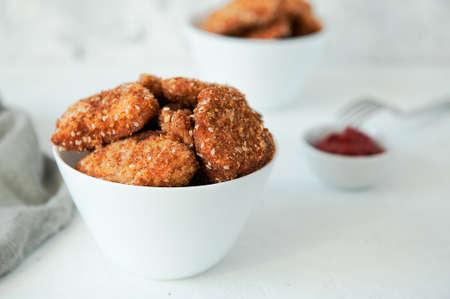 Homemade chicken nuggets with ketchup on a white table, top view, copy space. Fast food concept. Chicken chops.の写真素材