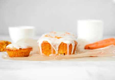 Homemade carrot muffin sliced on white table.の写真素材