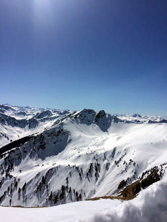 Winter snow covered mountain peaks in Austrian alps.の写真素材