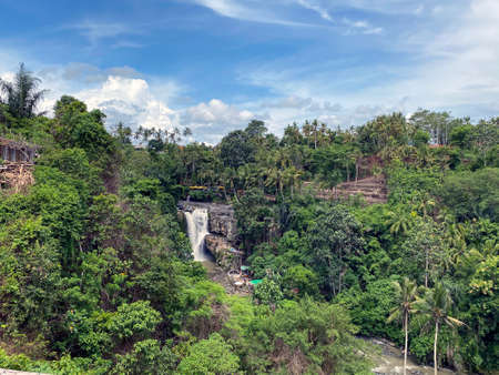 Waterfall flowing over rocky river in jungle, Bali, Indonesia - stock photoの写真素材