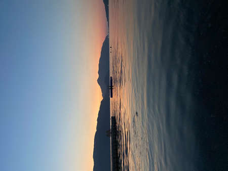 Tourist admiring the sunrise on tropical island - stock photoの写真素材