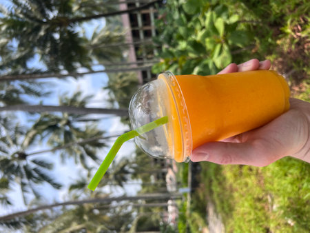 Delicious mango shake in a man hand. High quality photoの写真素材