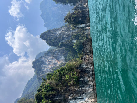Karst mountains above clear blue water in Khao Sok national park, Cheo Lan lake, Thailand. Beautiful...