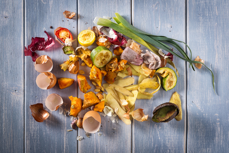 Organic leftovers, kitchem scraps, waste from vegetable ready for recycling and to compost. Collecting food leftovers for composting. Environmentally responsible behavior, ecology concept. Copy space.の写真素材