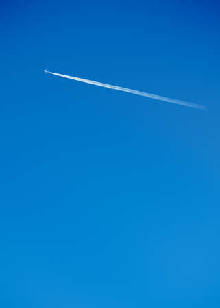 Vapour Trail of a Jet on a Clear Blue Skyの写真素材