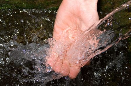  pouring mach water splashing on the  hand