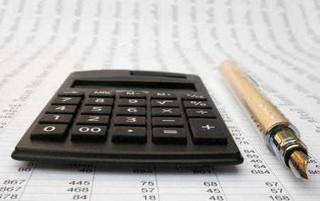 calculator and pen on a white backgroundの写真素材