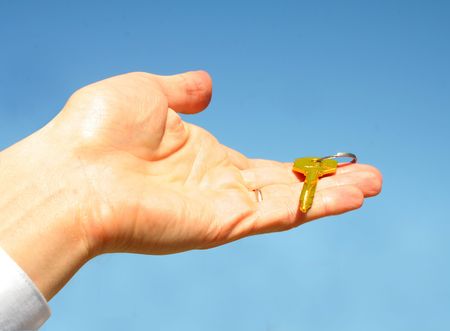  key in a palm over white backgroundの写真素材