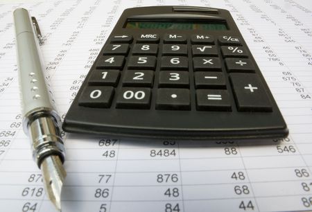 calculator and pen on a white backgroundの写真素材