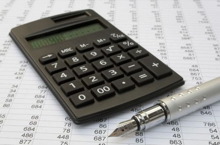 calculator and pen on a white background の写真素材