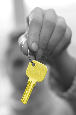 hand holds a key (key in focus)の写真素材