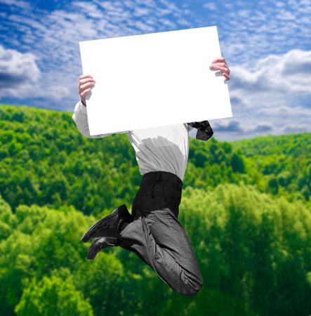 a businessman in air with empty advertisement の写真素材