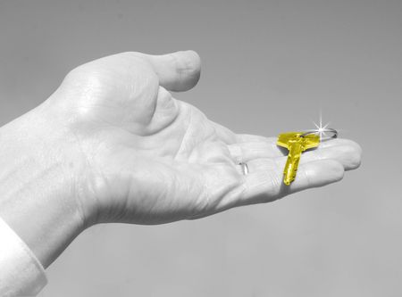  key in a palm over white backgroundの写真素材