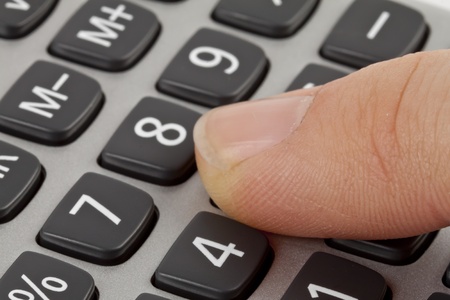 calculator with hand isolated on whiteの写真素材