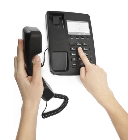 office black telephone with hand isolated on whiteの写真素材