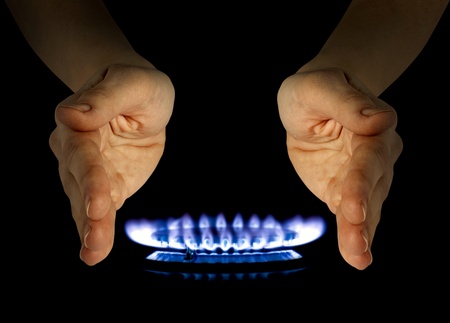 blue gas in hands on the blackの写真素材