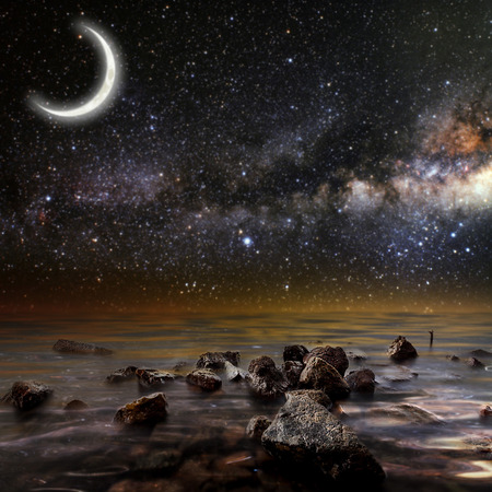 month on a background star sky reflected in the sea. Elements of this image furnished by NASAの写真素材