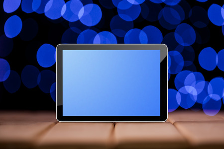 Tablet on the blue bokeh backrounds. Like ipadeの写真素材