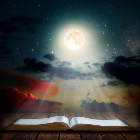 book on the table under the night sky.の写真素材