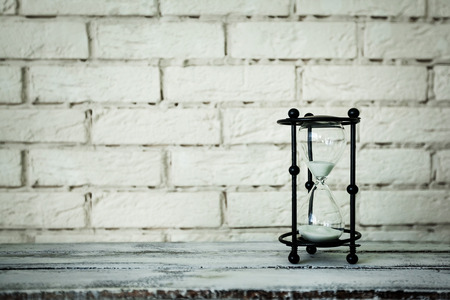 hourglass on a brick backgroundの写真素材