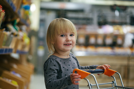 child in the store buys foodの写真素材