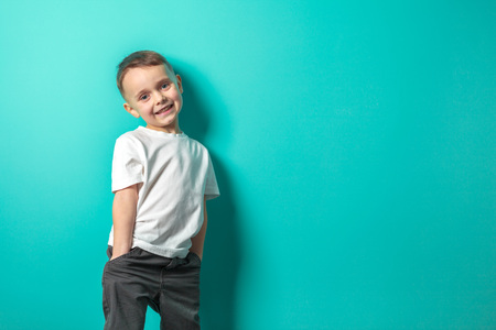 model child posing on turquoise backgroundの写真素材