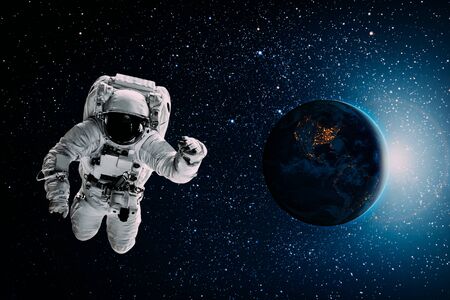 astronaut flies over the earth in space.の写真素材