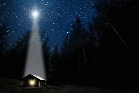 The moon shines over the manger of christmas of Jesus Christ.の写真素材