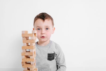 a boy child playing with a block at home
