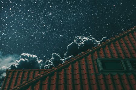 the roof of the house under the night blue skyの写真素材