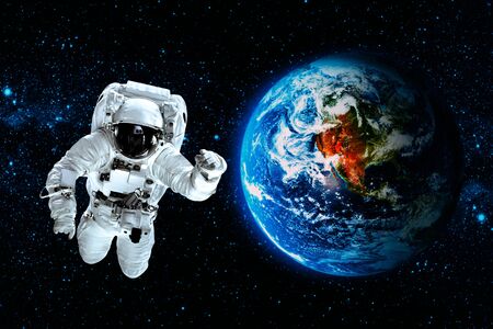 astronaut flies over the earth in space.