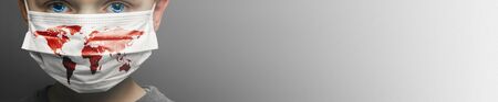 Face of a mask-wearing boy with fear in the eye Close-up on a gray background.Coronavirus and Air...