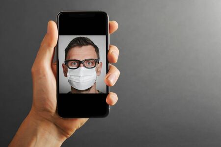 cellphone phone tablet in hand for advertisement on the gray backgroundsの写真素材