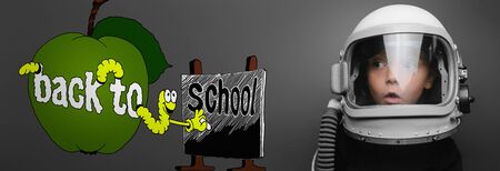 Small child wants to fly an airplane wearing an airplane helmetの写真素材