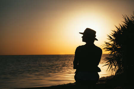 forces a girl who meditates at sunset on the seaの写真素材