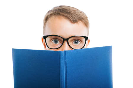 child reads a book against a bright wallの写真素材