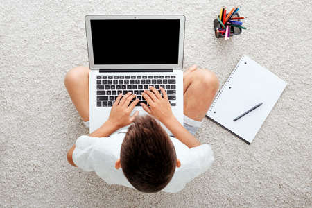 school at home through online homeschooling. the child is sitting at the computer