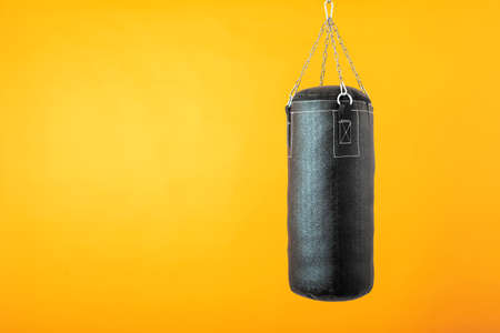 punching bag hanging on colorful background with blank spaceの写真素材