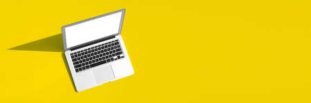 modern laptop computer on the tabl on the color backgroundの写真素材