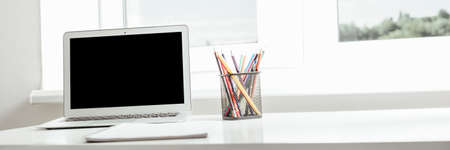 school at home through online homeschooling. the child is sitting at the computerの写真素材
