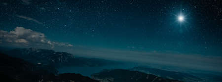 The star shines over the manger of christmas of Jesus Christ.