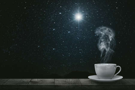 hot coffee on the table on a night backgroundの写真素材