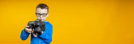The child learns the profession of a photographer in the studio from his father