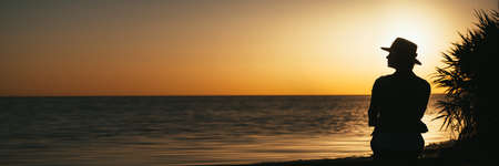 forces a girl who meditates at sunset on the sea