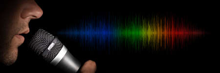 a man holding a microphone on a black background