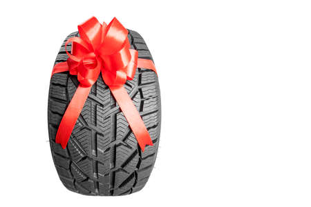 black isolation rubber tire, on the white backgrounds in a bow for christmasの写真素材